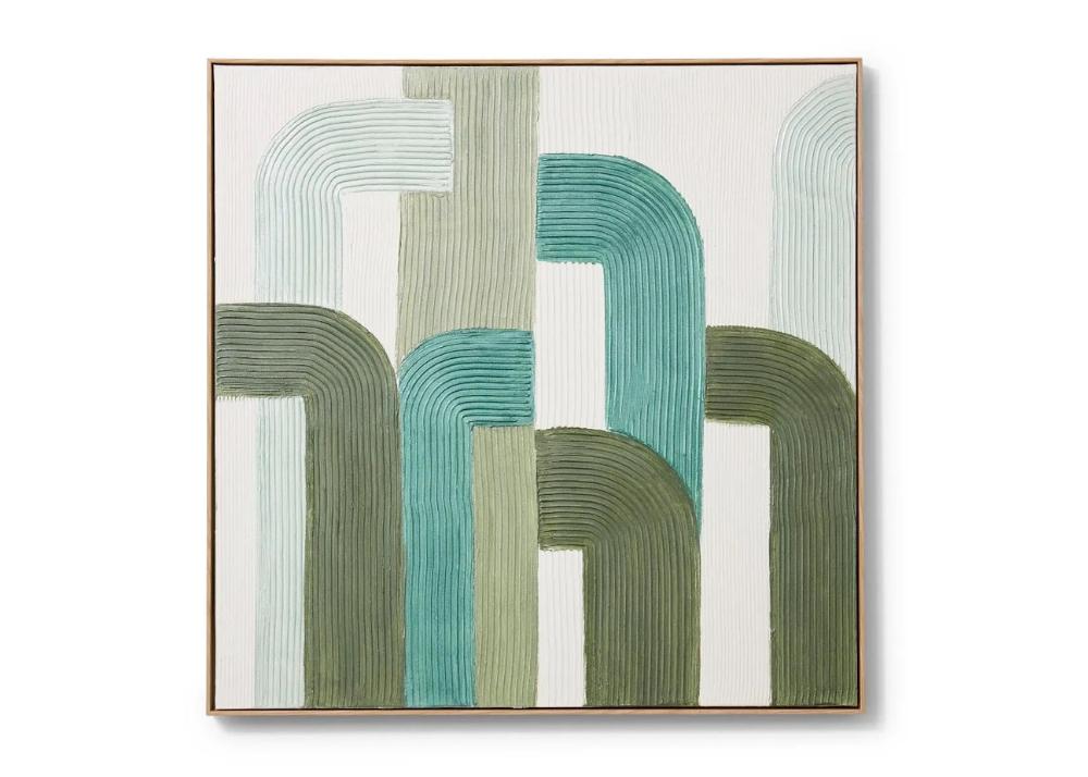 A green and white abstract painting on a wall.
