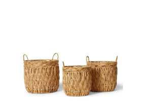 Three rattan baskets with handles on a white background.	