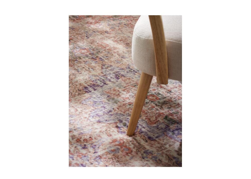 Close up of A blue and beige rug with fringes on a white background.